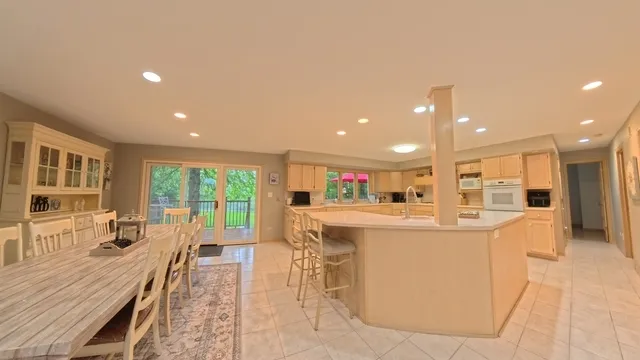 a large kitchen with kitchen island a large island in the center