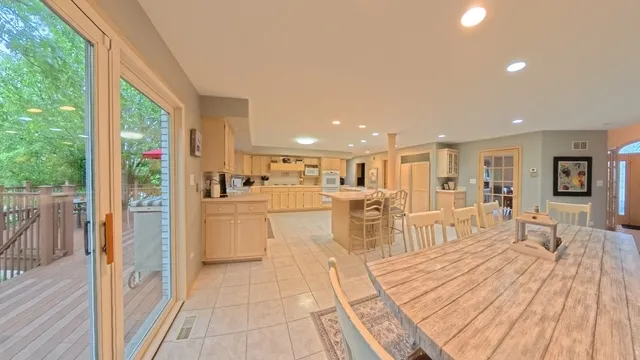 a living room with furniture a wooden floor and a large window