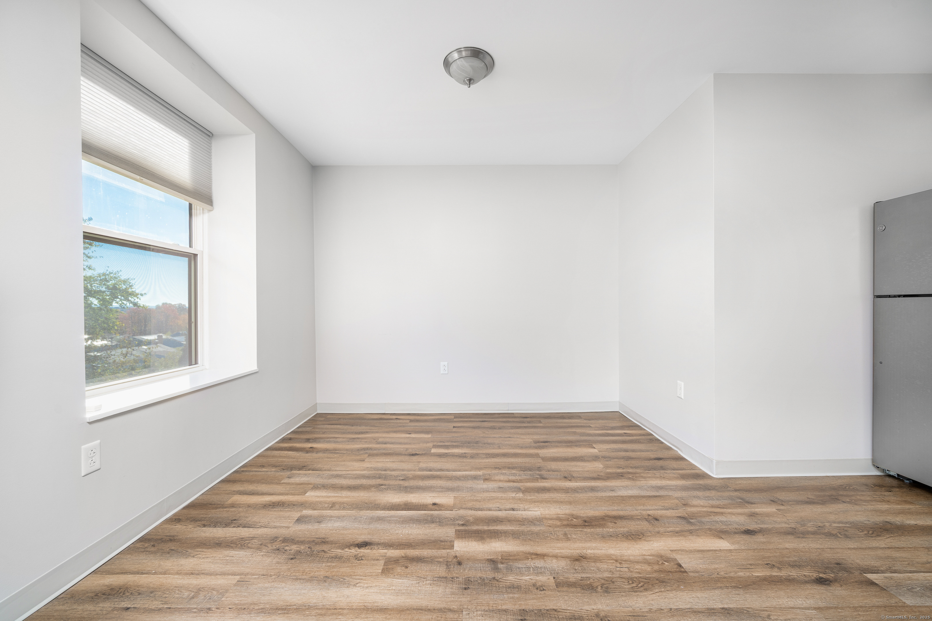 170 Ridge Road, Unit 103 Wethersfield, CT 06109 - Photo 12 of 24 a view of an empty room with wooden floor and a window