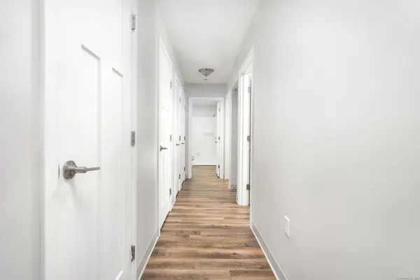 a view of a hallway with wooden floor