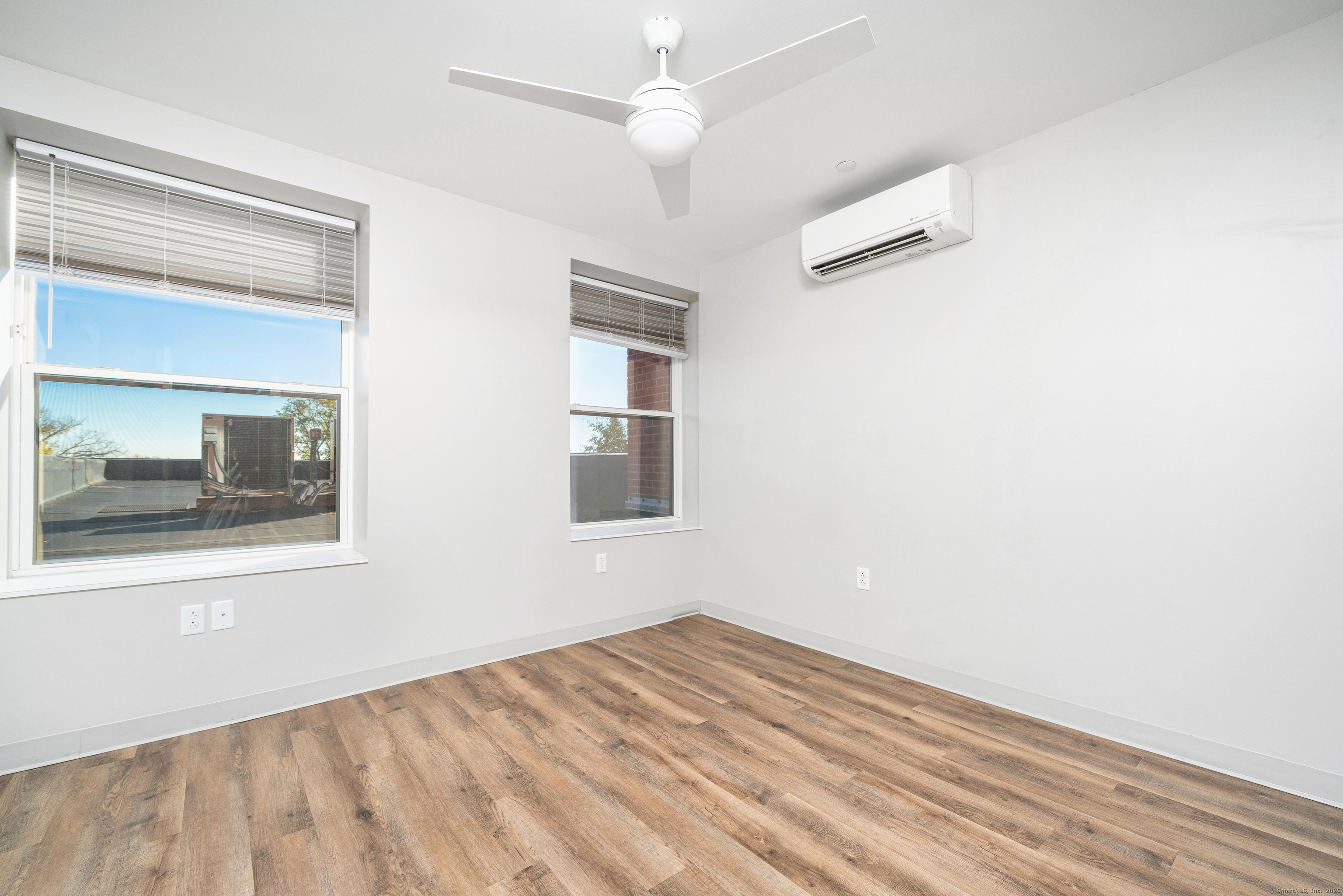 170 Ridge Road, Unit 103 Wethersfield, CT 06109 - Photo 18 of 24 a view of empty room with wooden floor and fan