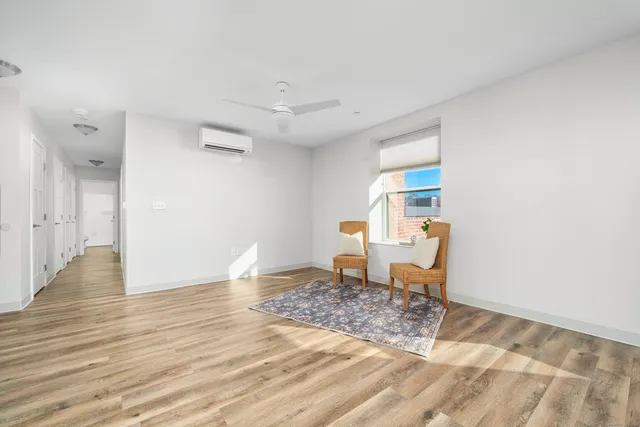 a view of a livingroom with wooden floor and chair