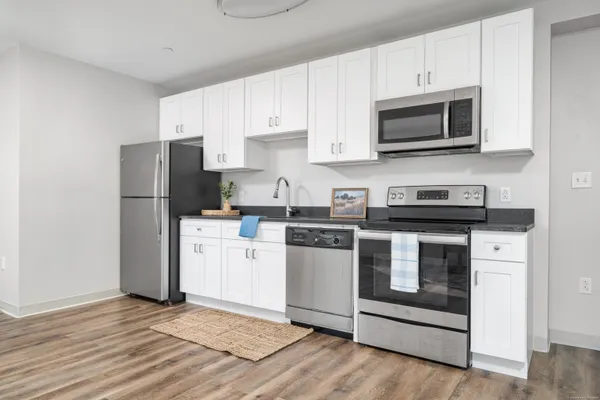 a kitchen with a refrigerator stove and microwave