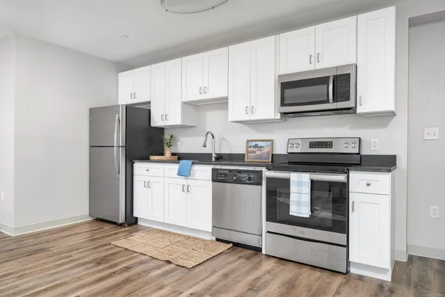 a kitchen with a refrigerator stove and microwave