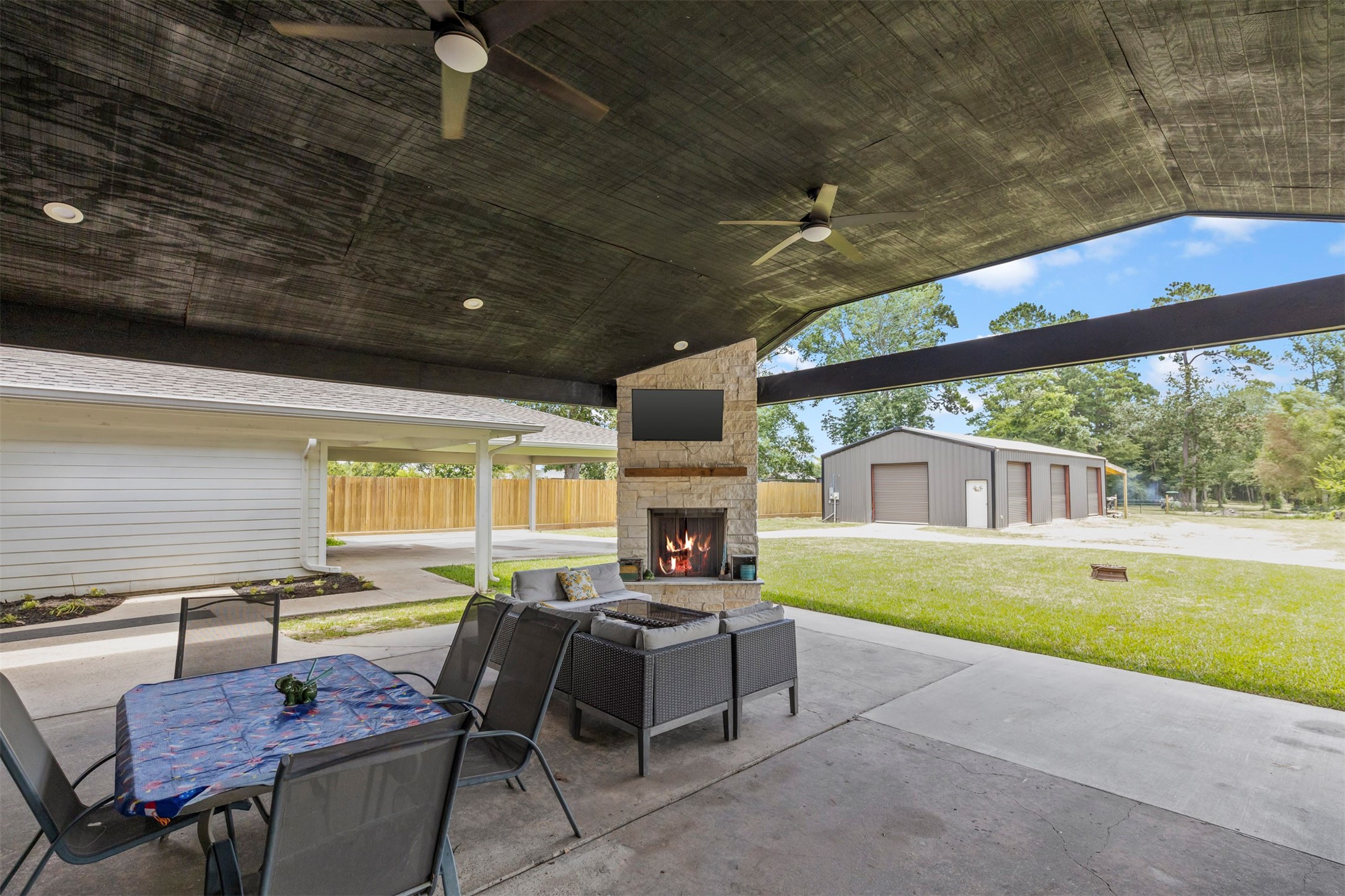 18022 Rogers Road New Waverly, TX 77358 - Photo 43 of 49 Wood Burning Fireplace Under Covered Veranda