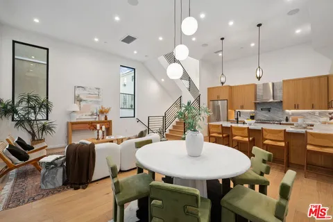 a kitchen with a dining table and chairs
