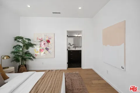 a bathroom with a double vanity sink toilet and mirror