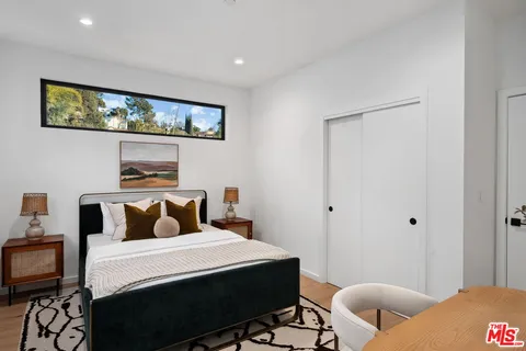 a bedroom with a large bed and a large window