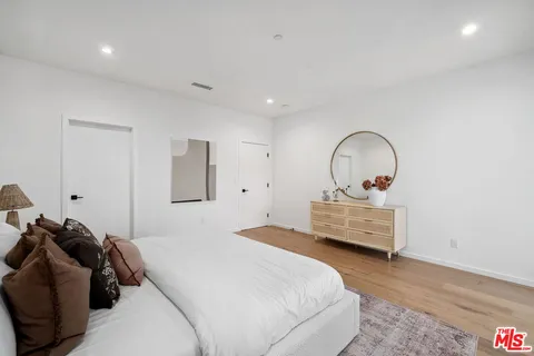 a white bath tub sitting next to a white sink and a shower