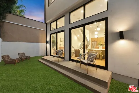 a view of a terrace with couches and wooden floor