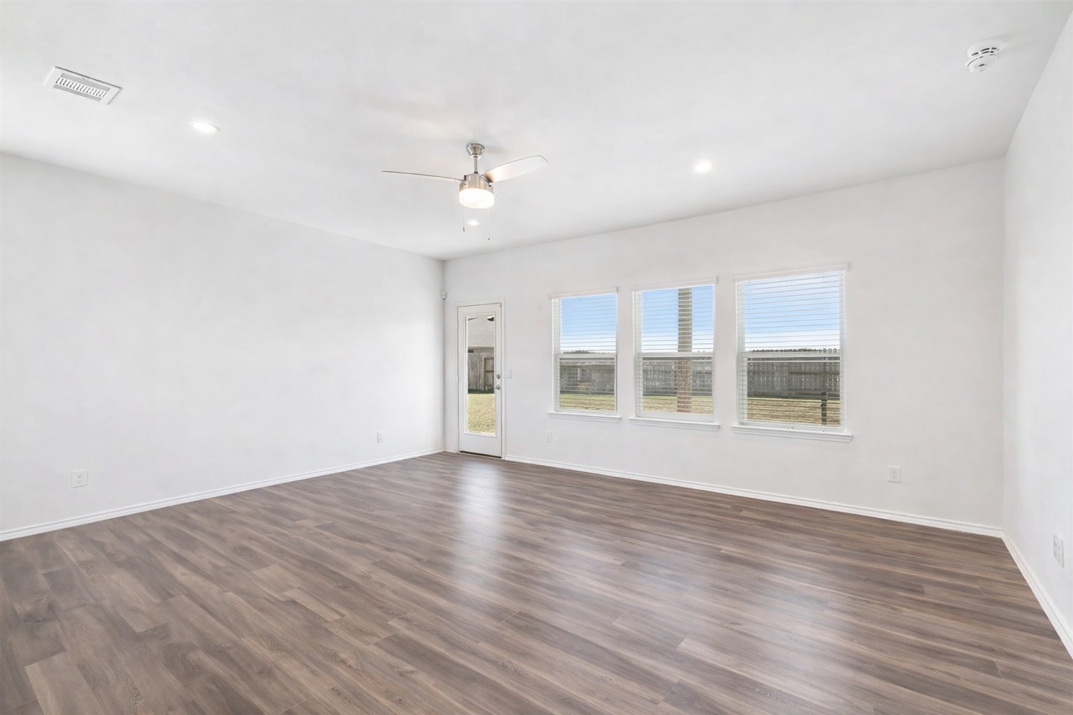 306 Springfield Shrs Court Crosby, TX 77532 - Photo 11 of 31 a view of an empty room with a window and wooden floor