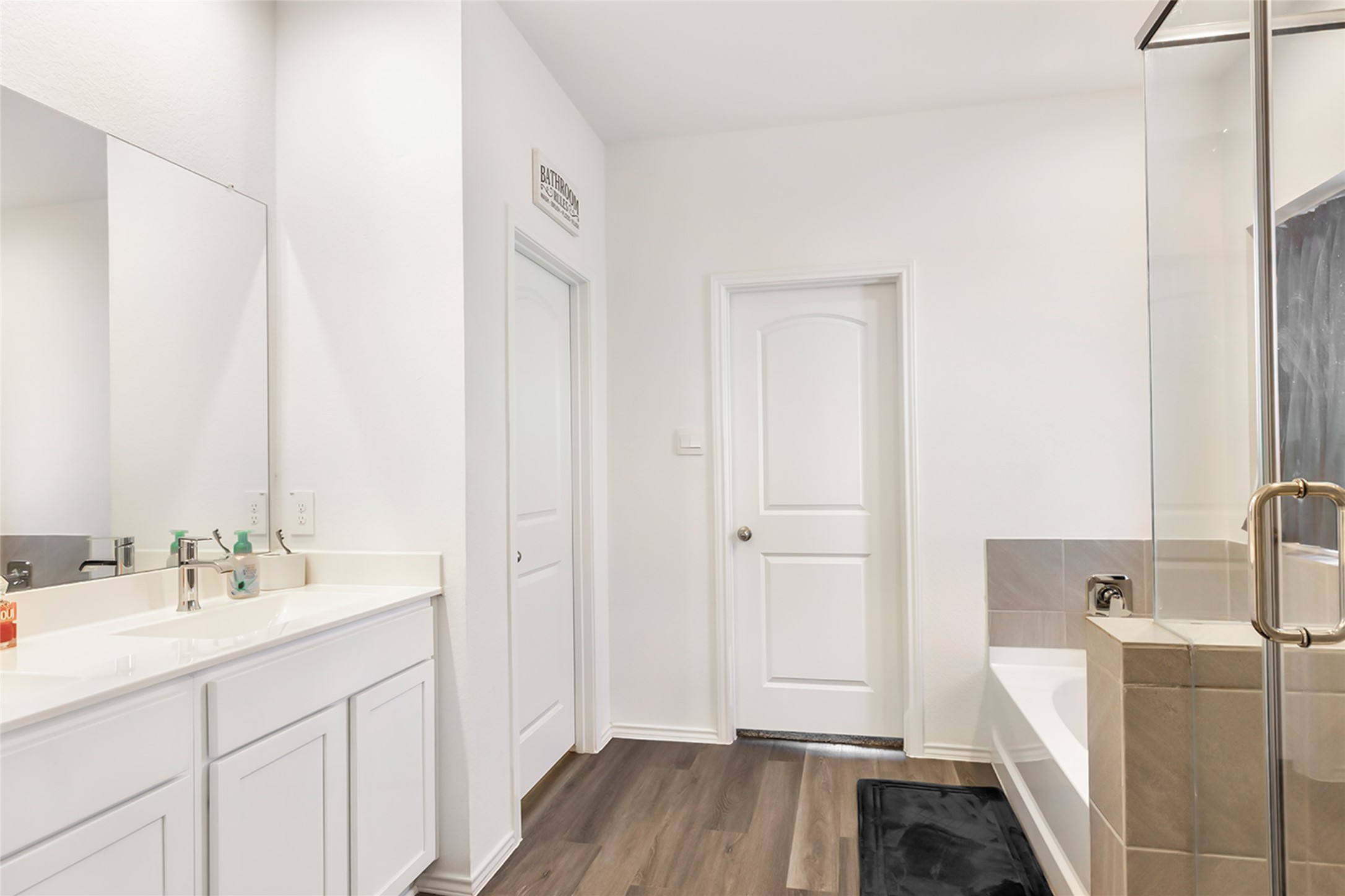 306 Springfield Shrs Court Crosby, TX 77532 - Photo 20 of 31 a spacious bathroom with a double vanity sink a mirror and a bathtub