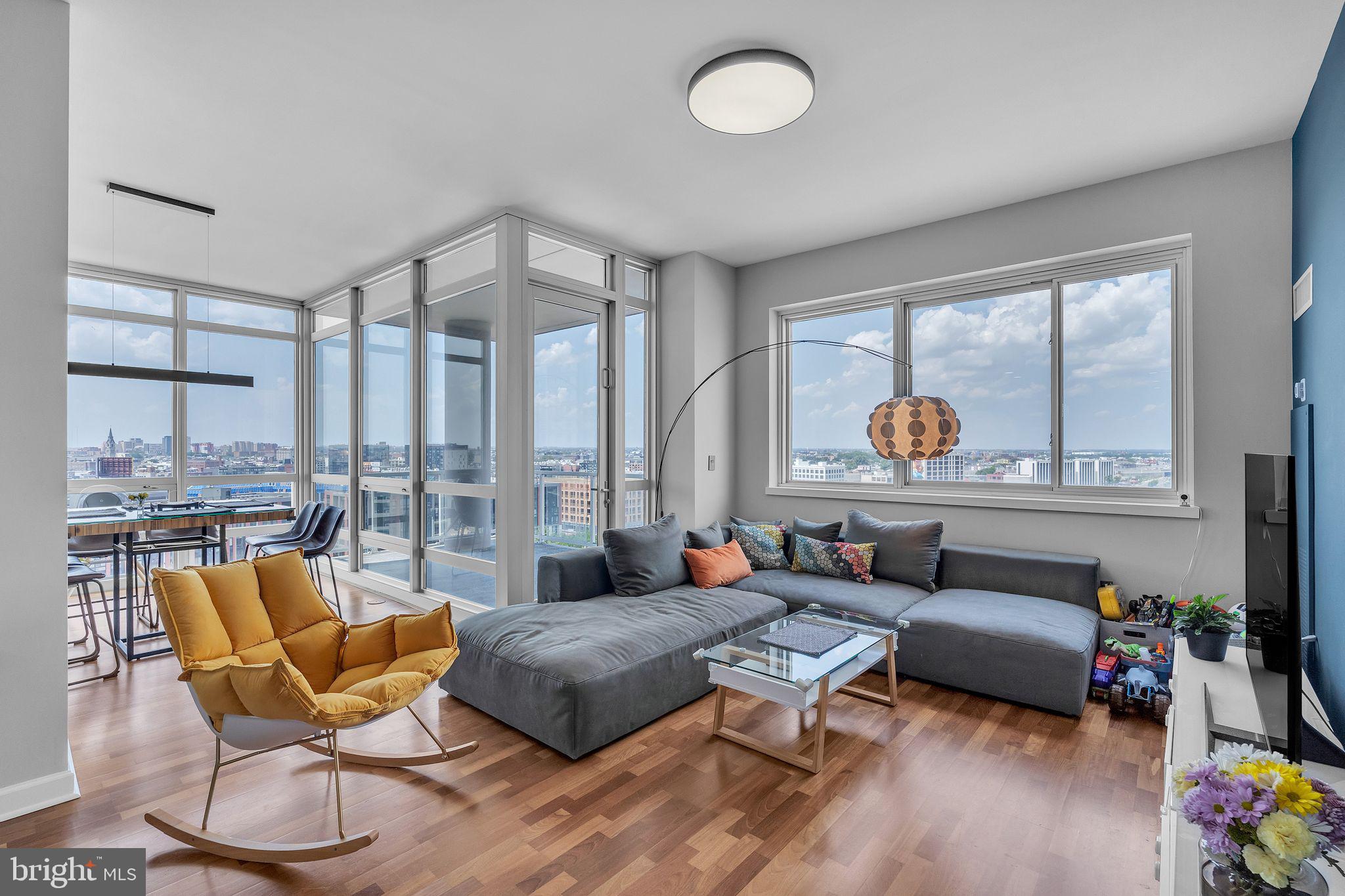 a living room with furniture and a floor to ceiling window