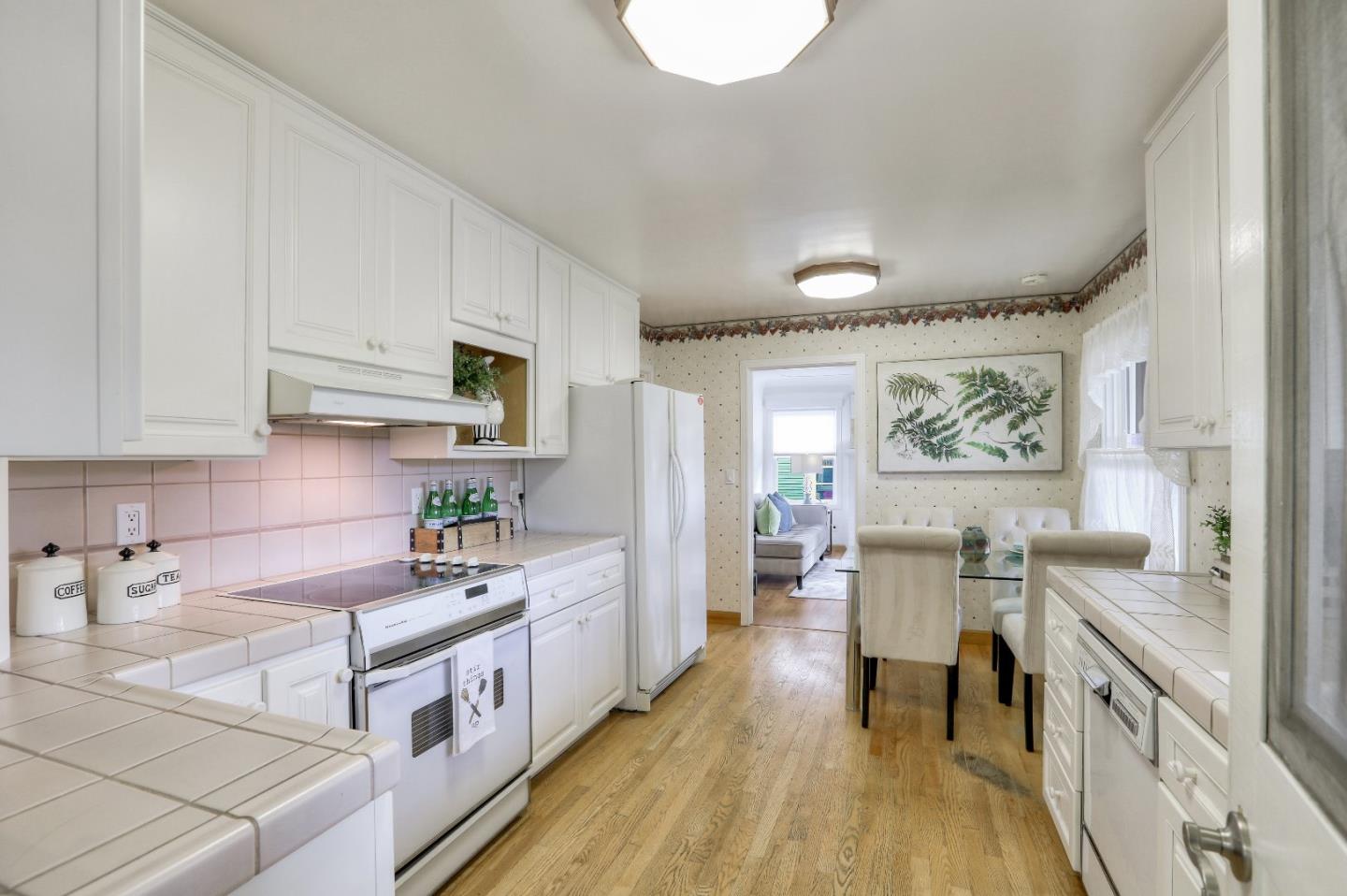 66 Church Street Mountain View, CA 94041 - Photo 13 of 45 a large white kitchen with stainless steel appliances