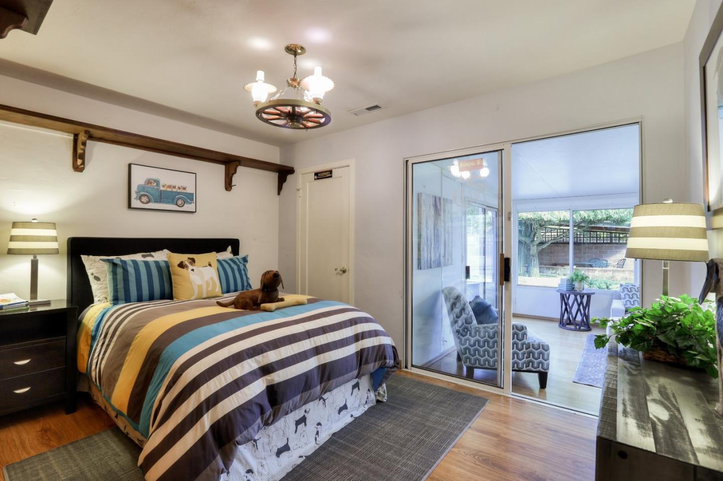 66 Church Street Mountain View, CA 94041 - Photo 17 of 45 a bedroom with bed and a chandelier
