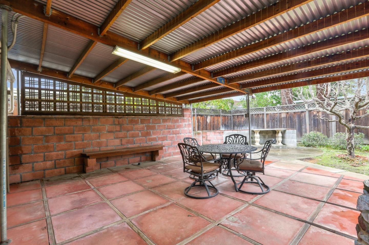66 Church Street Mountain View, CA 94041 - Photo 39 of 45 a view of a patio with table and chairs with wooden floor and fence