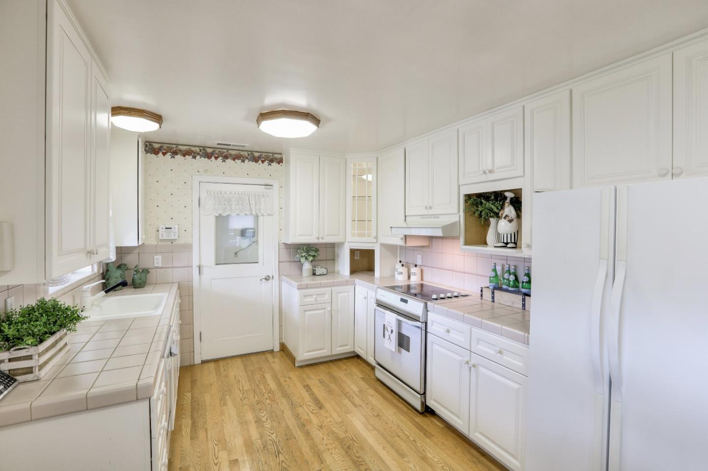 66 Church Street Mountain View, CA 94041 - Photo 9 of 45 a kitchen with white cabinets and white appliances