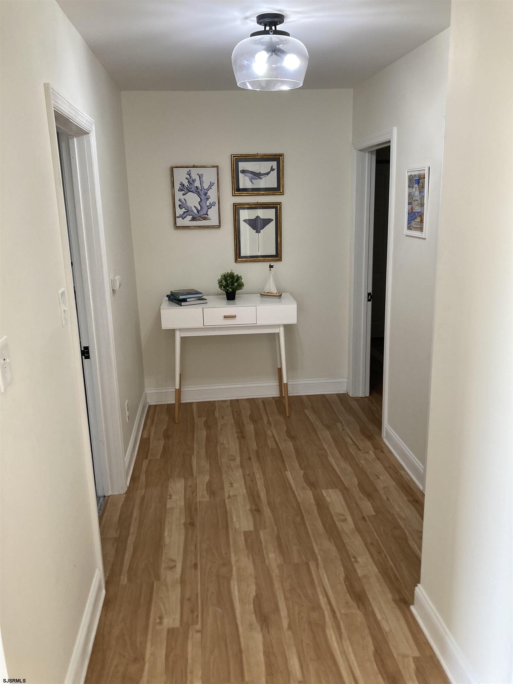273 38th Street South, Unit A / B Brigantine, NJ 08203 - Photo 3 of 7 a view of a hallway with wooden floor and workspace