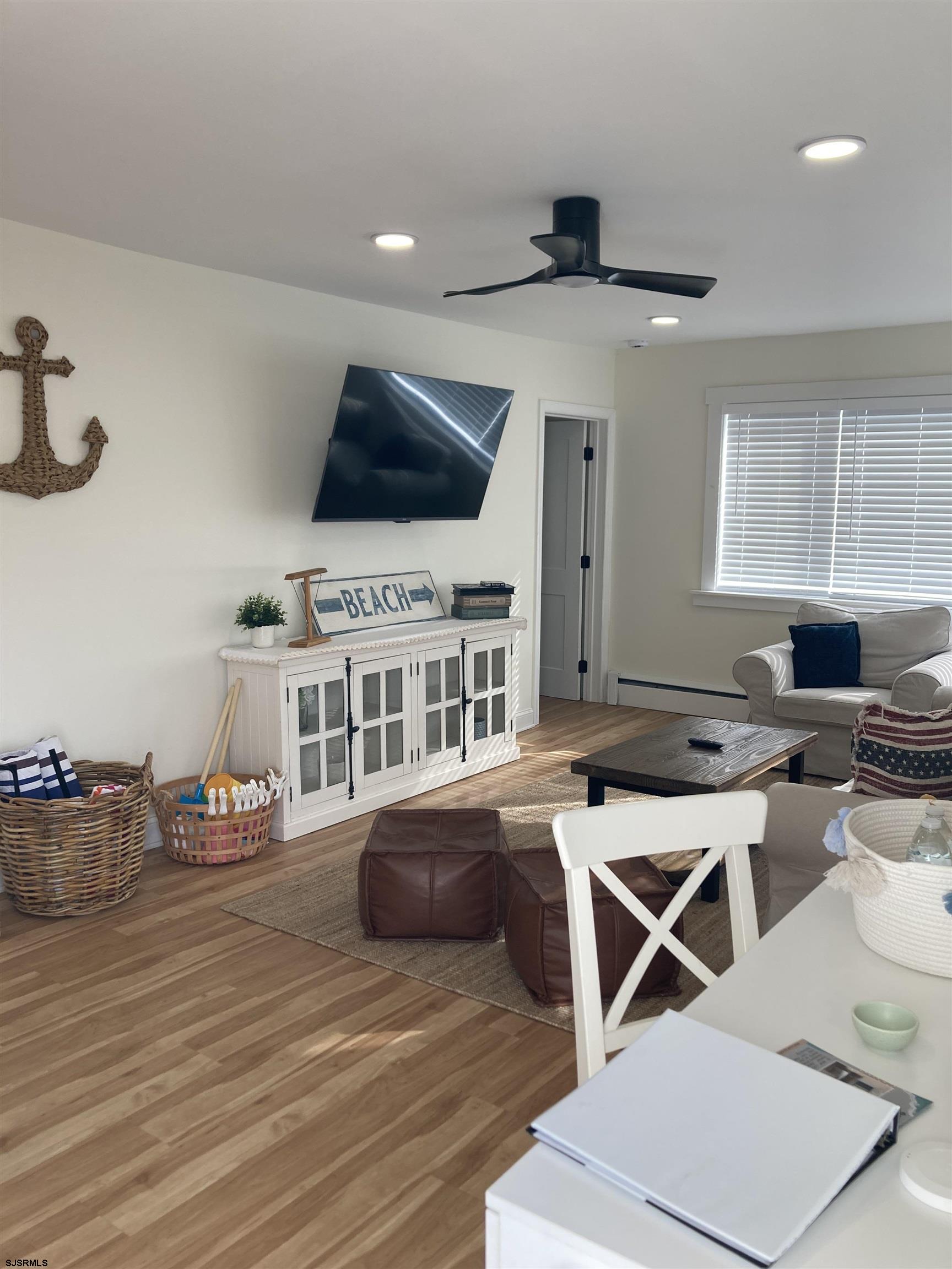 273 38th Street South, Unit A / B Brigantine, NJ 08203 - Photo 4 of 7 a living room with furniture a flat screen tv and kitchen view
