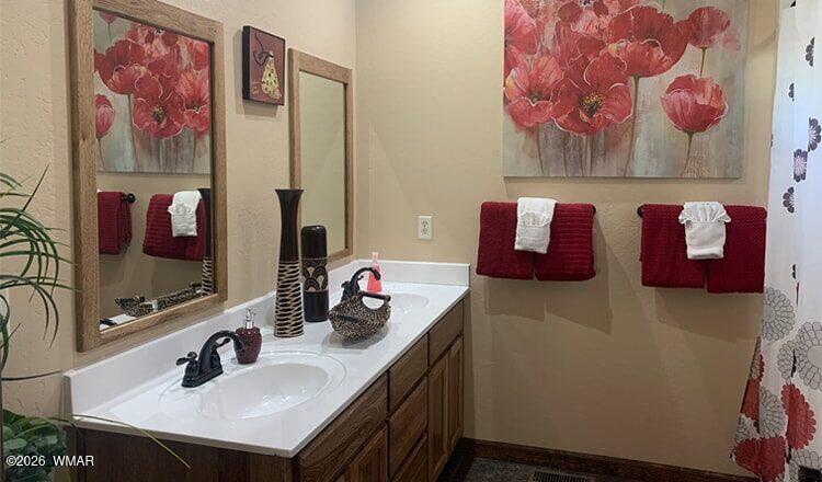 97 Rohrer Road Greer, AZ 85927 - Photo 11 of 14 a bathroom with a sink mirror and vanity