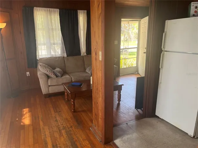 a view of a hallway with furniture and a window