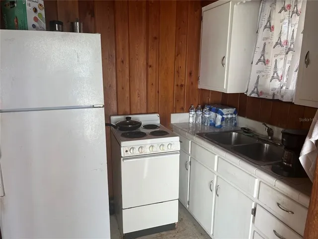 a white refrigerator freezer sitting inside of a kitchen