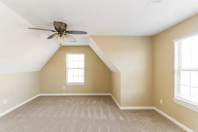 a bathroom with a granite countertop sink a mirror and a shower