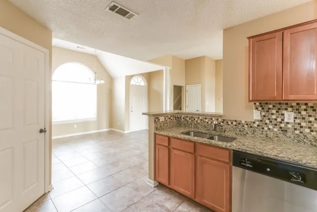 a kitchen with a sink stove and refrigerator