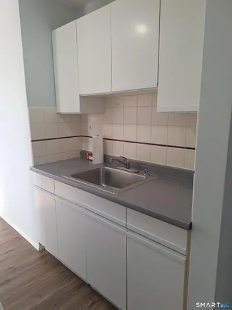a kitchen with a sink and cabinets