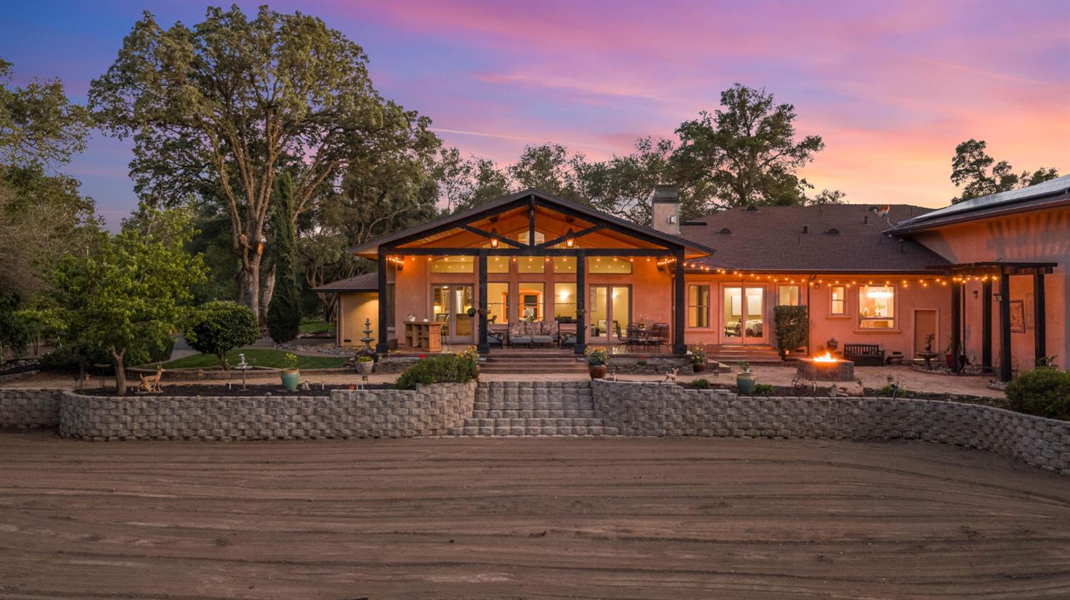 7021 Horseshoe Bar Road Loomis, CA 95650 - Photo 74 of 77 Twilight view of the home's stunning rear elevation and outdoor peaceful living spaces.