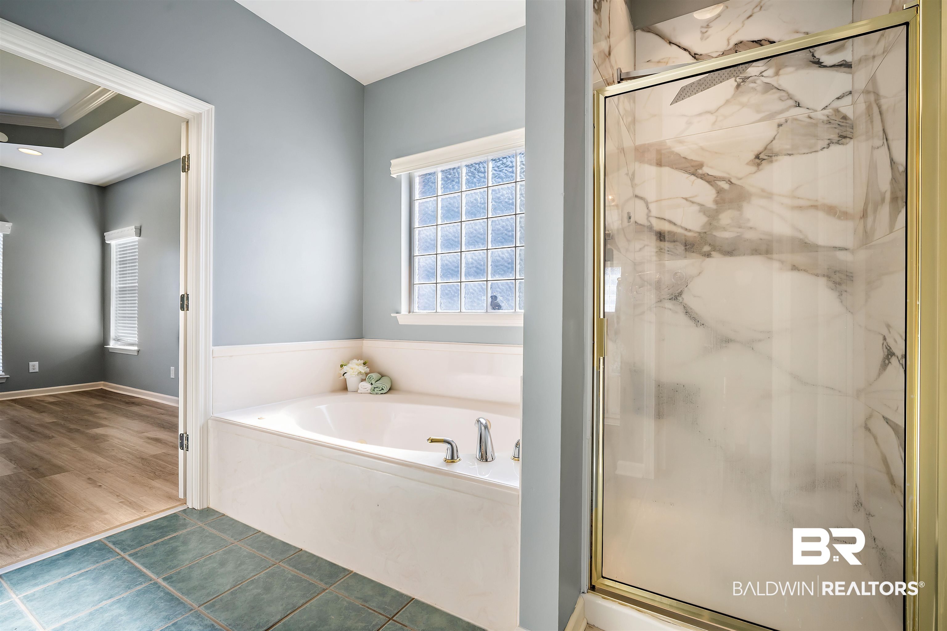 615 Summerlake Place Mobile, AL 36608 - Photo 20 of 35 Bathroom with a marble finish shower, a garden tub, and dark tile patterned flooring