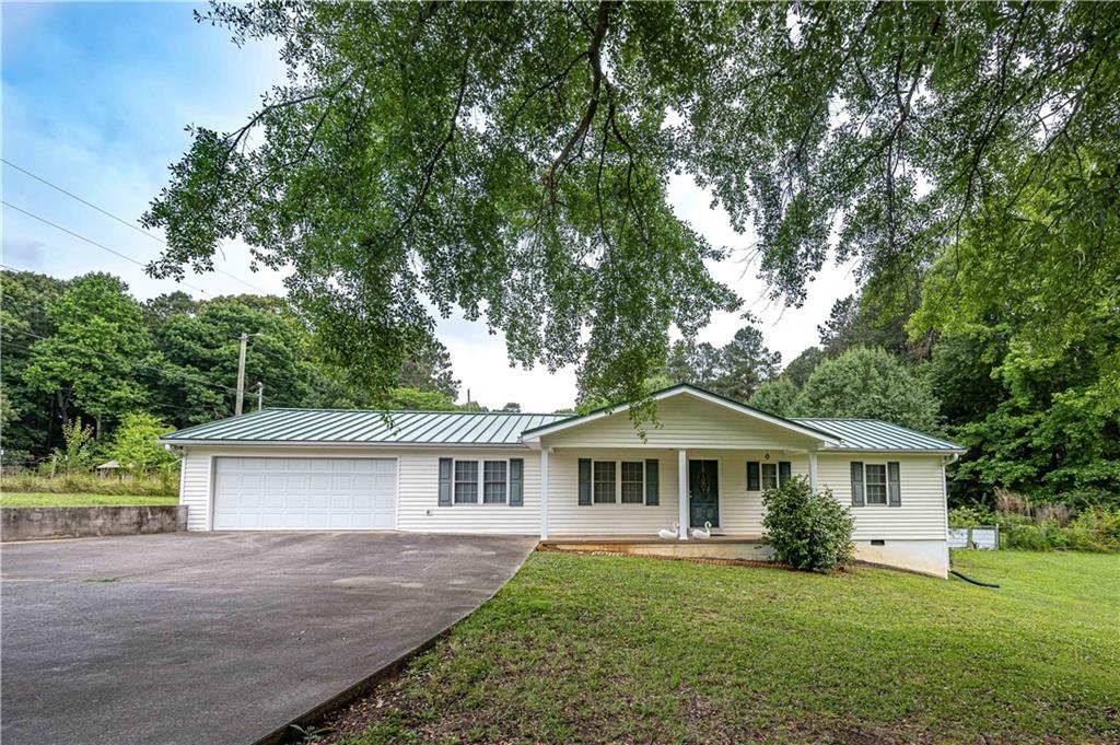 1795 Cole Creek Road Dallas, GA 30157 - Photo 1 of 1 a front view of a house with a garden and trees