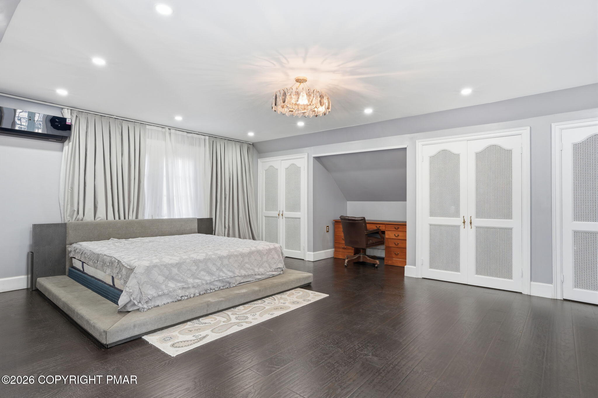 720 Stokes Mill Road East Stroudsburg, PA 18301 - Photo 36 of 87 a spacious bedroom with a large bed and a chandelier