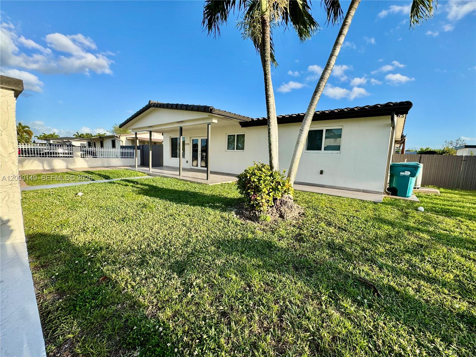 11770 Southwest 178th Terrace Miami, FL 33177 - Photo 2 of 13 a front view of a house with garden