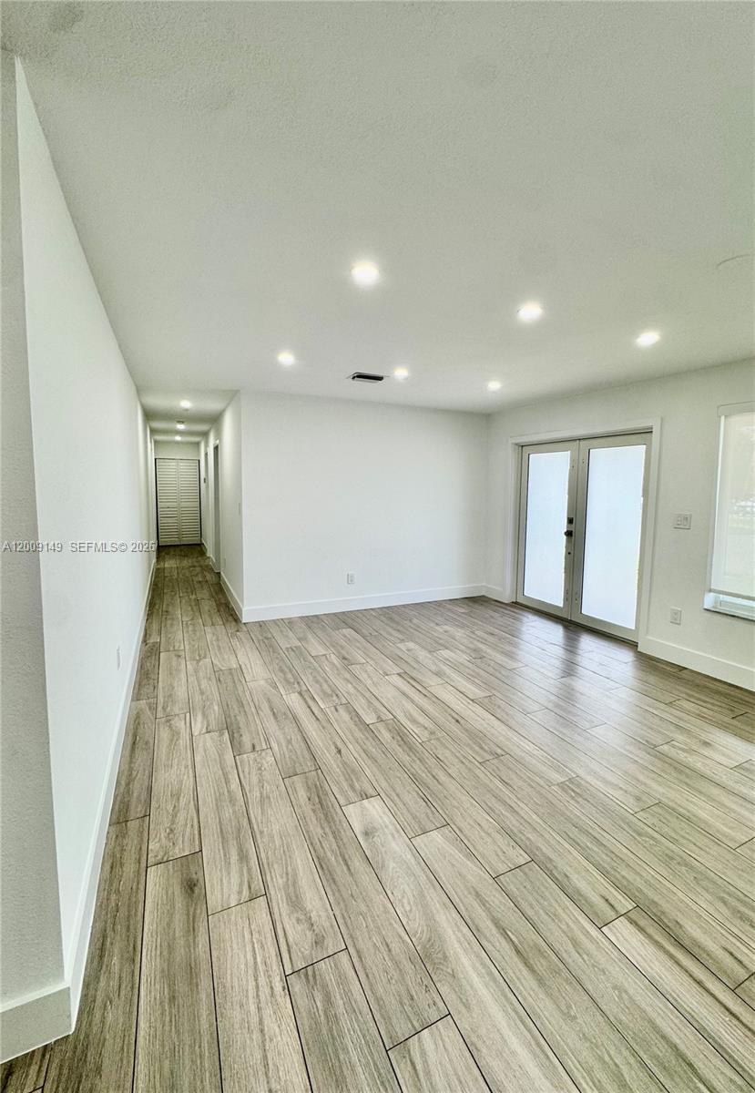 11770 Southwest 178th Terrace Miami, FL 33177 - Photo 3 of 13 a view of a room with wooden floor and window