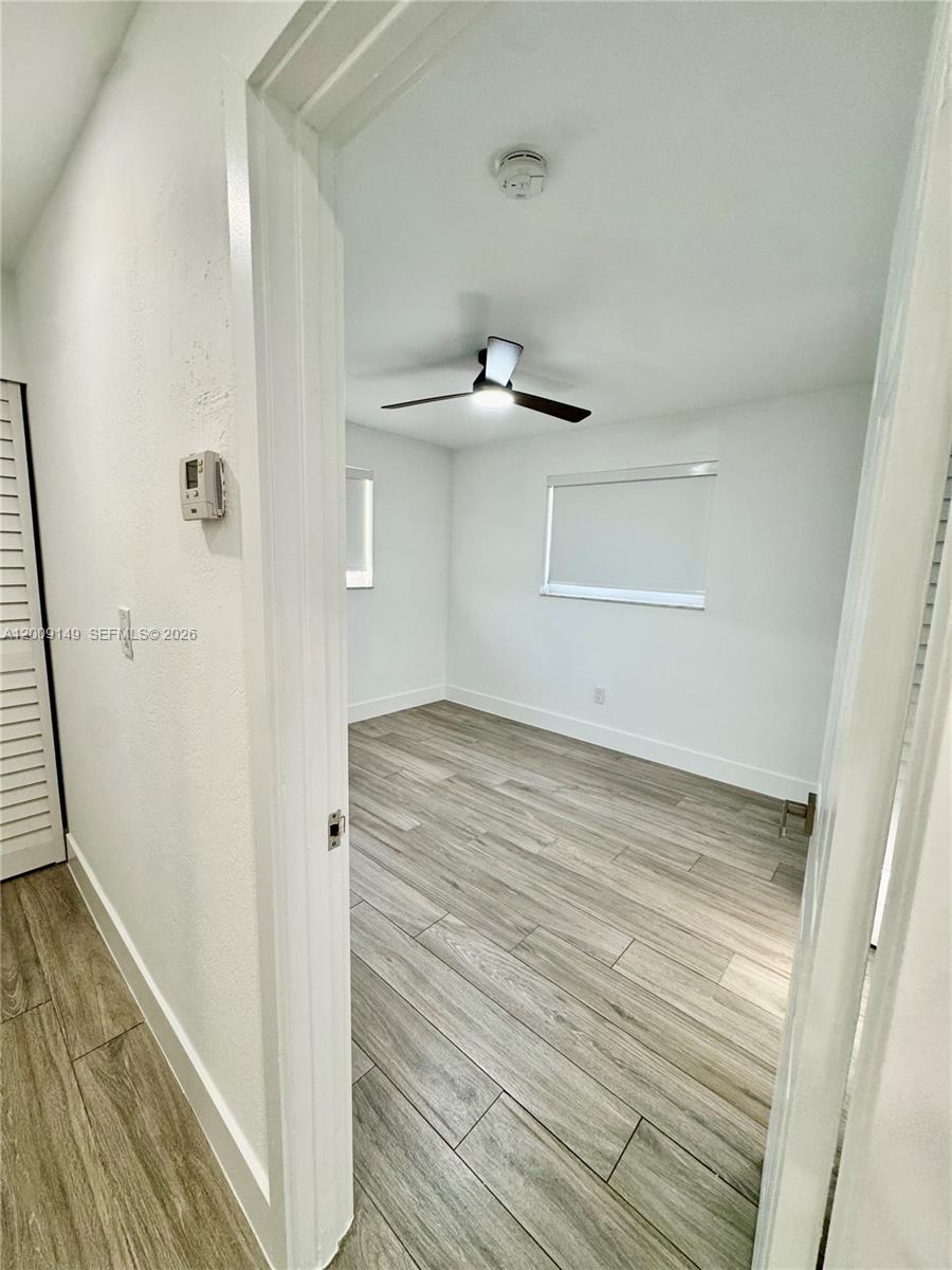11770 Southwest 178th Terrace Miami, FL 33177 - Photo 8 of 13 a view of empty room with wooden floor