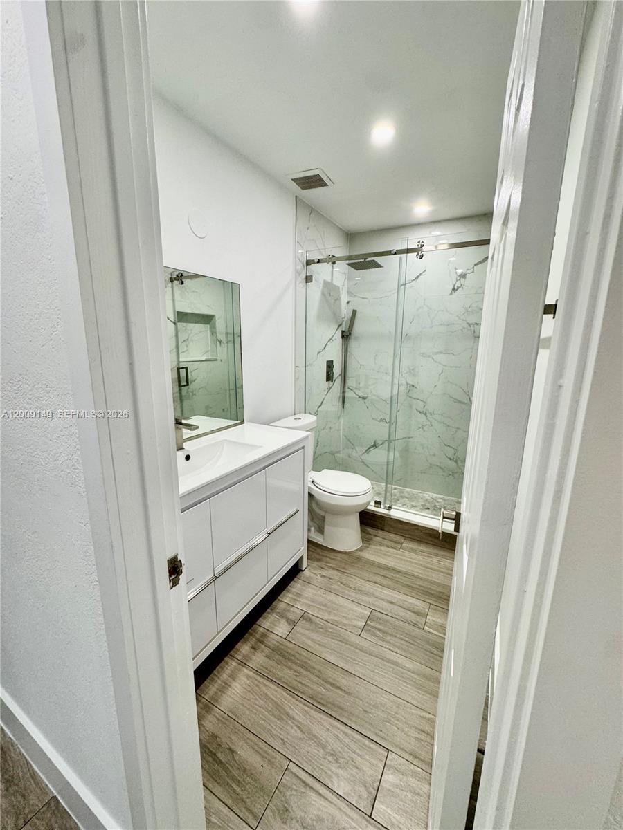 11770 Southwest 178th Terrace Miami, FL 33177 - Photo 9 of 13 a bathroom with a sink a toilet and shower