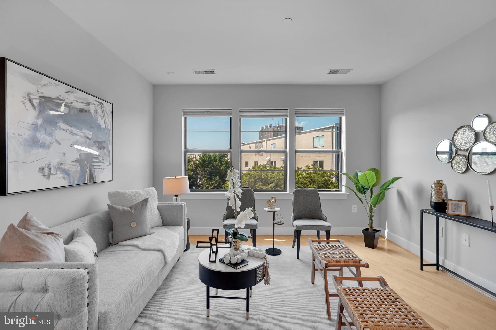 5201 Wisconsin Avenue Northwest, Unit 402 Washington, DC 20015 - Photo 1 of 39 a living room with furniture and a large window