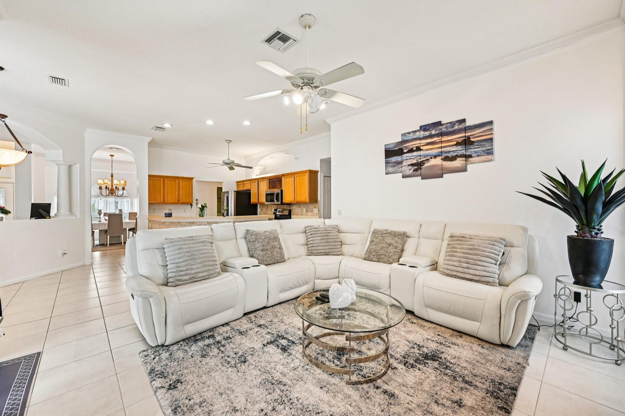 2041 Southwest Villanova Road Port St. Lucie, FL 34953 - Photo 11 of 45 a living room with furniture kitchen view and a potted plant