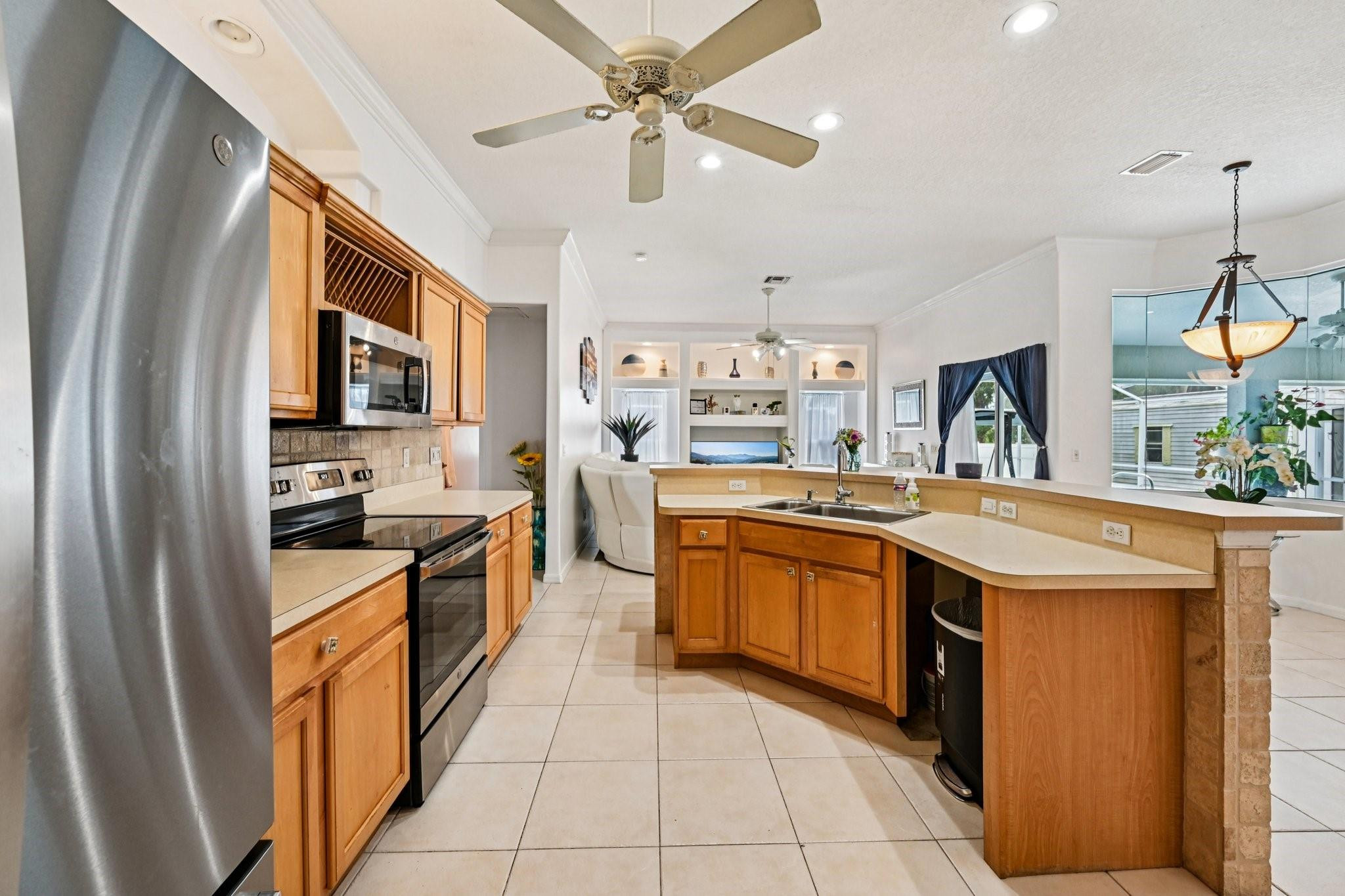 2041 Southwest Villanova Road Port St. Lucie, FL 34953 - Photo 13 of 45 a kitchen with stainless steel appliances granite countertop a stove a sink dishwasher and a refrigerator