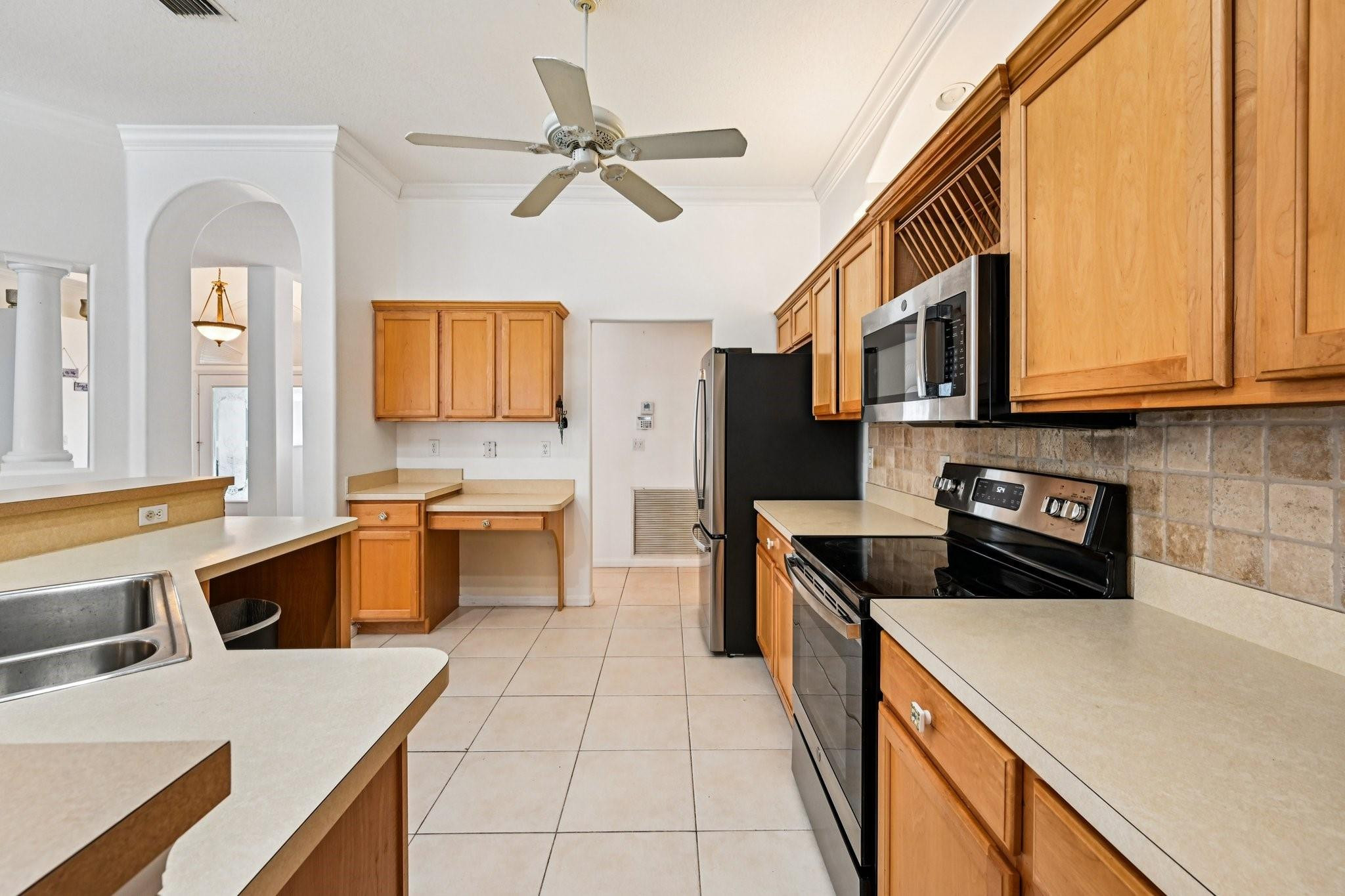 2041 Southwest Villanova Road Port St. Lucie, FL 34953 - Photo 15 of 45 a kitchen with a stove a sink and a microwave