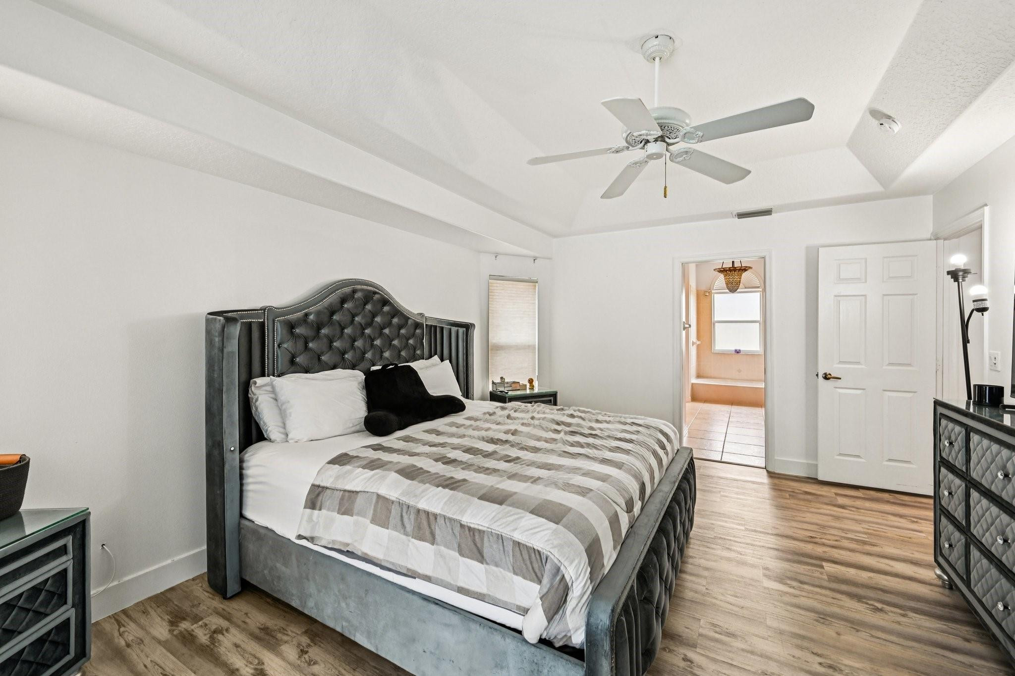 2041 Southwest Villanova Road Port St. Lucie, FL 34953 - Photo 18 of 45 a bedroom with a bed and wooden floor