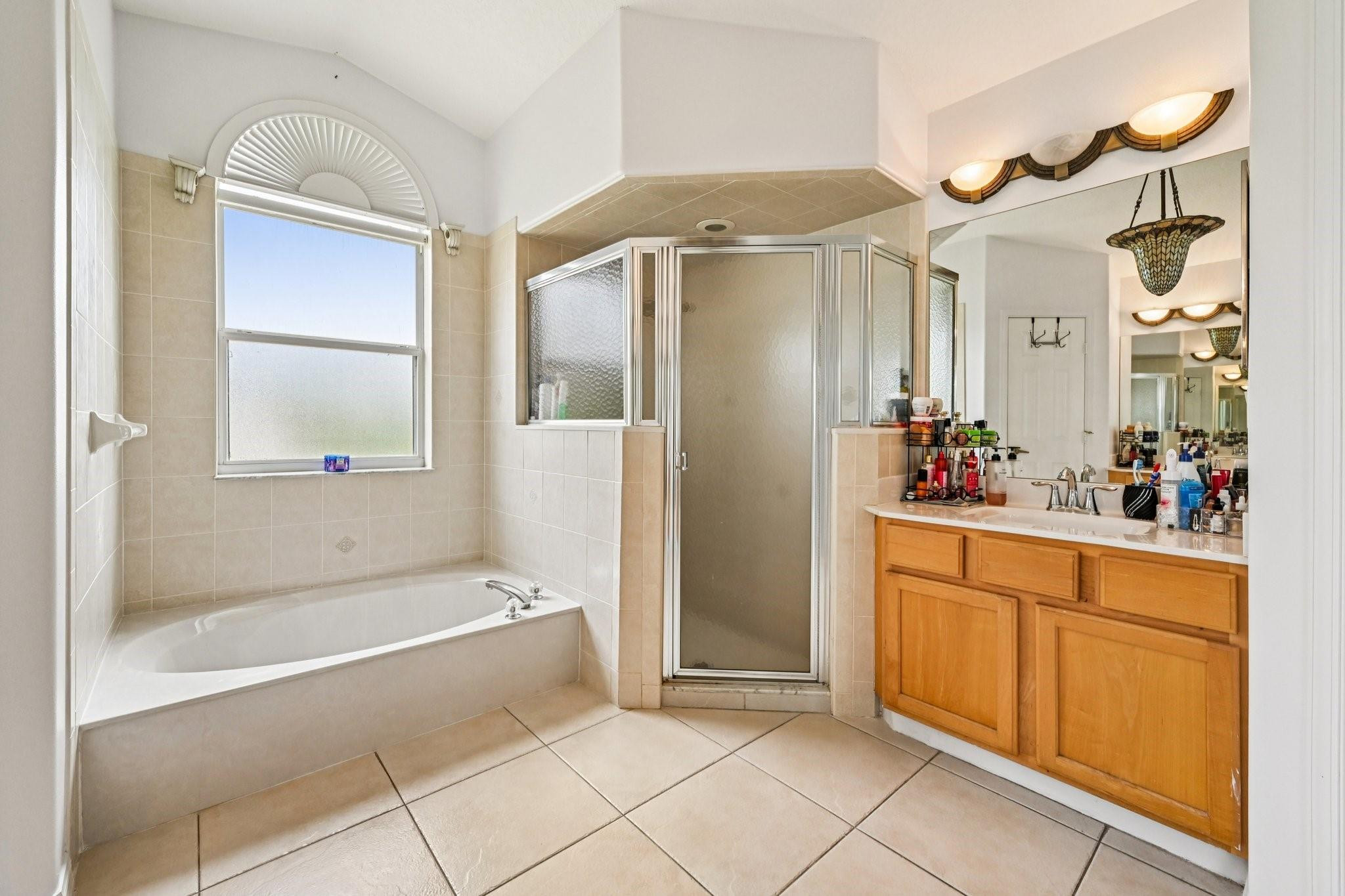 2041 Southwest Villanova Road Port St. Lucie, FL 34953 - Photo 21 of 45 a bathroom with a tub shower and sink