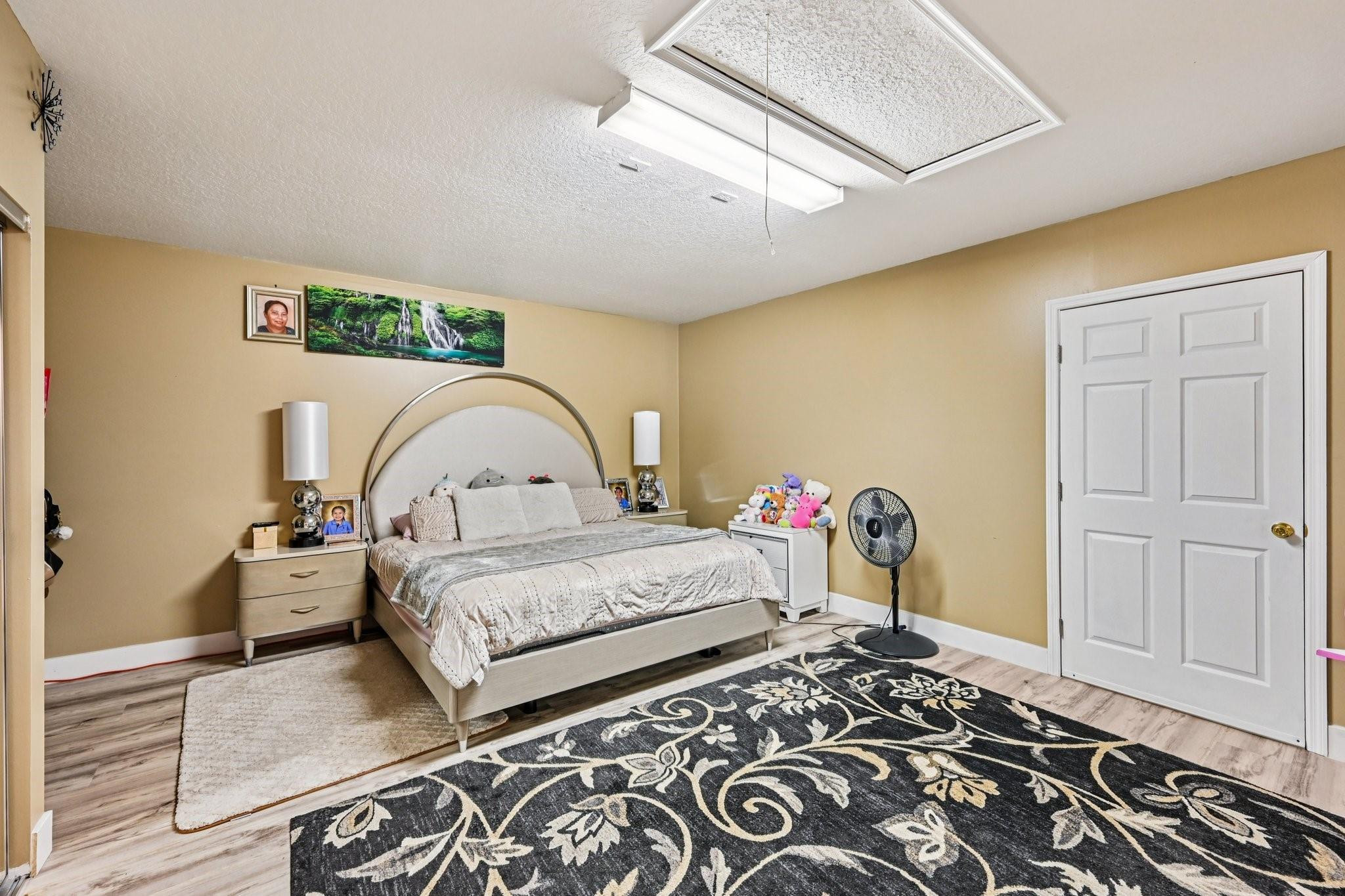 2041 Southwest Villanova Road Port St. Lucie, FL 34953 - Photo 23 of 45 a bedroom with bed and wooden floor