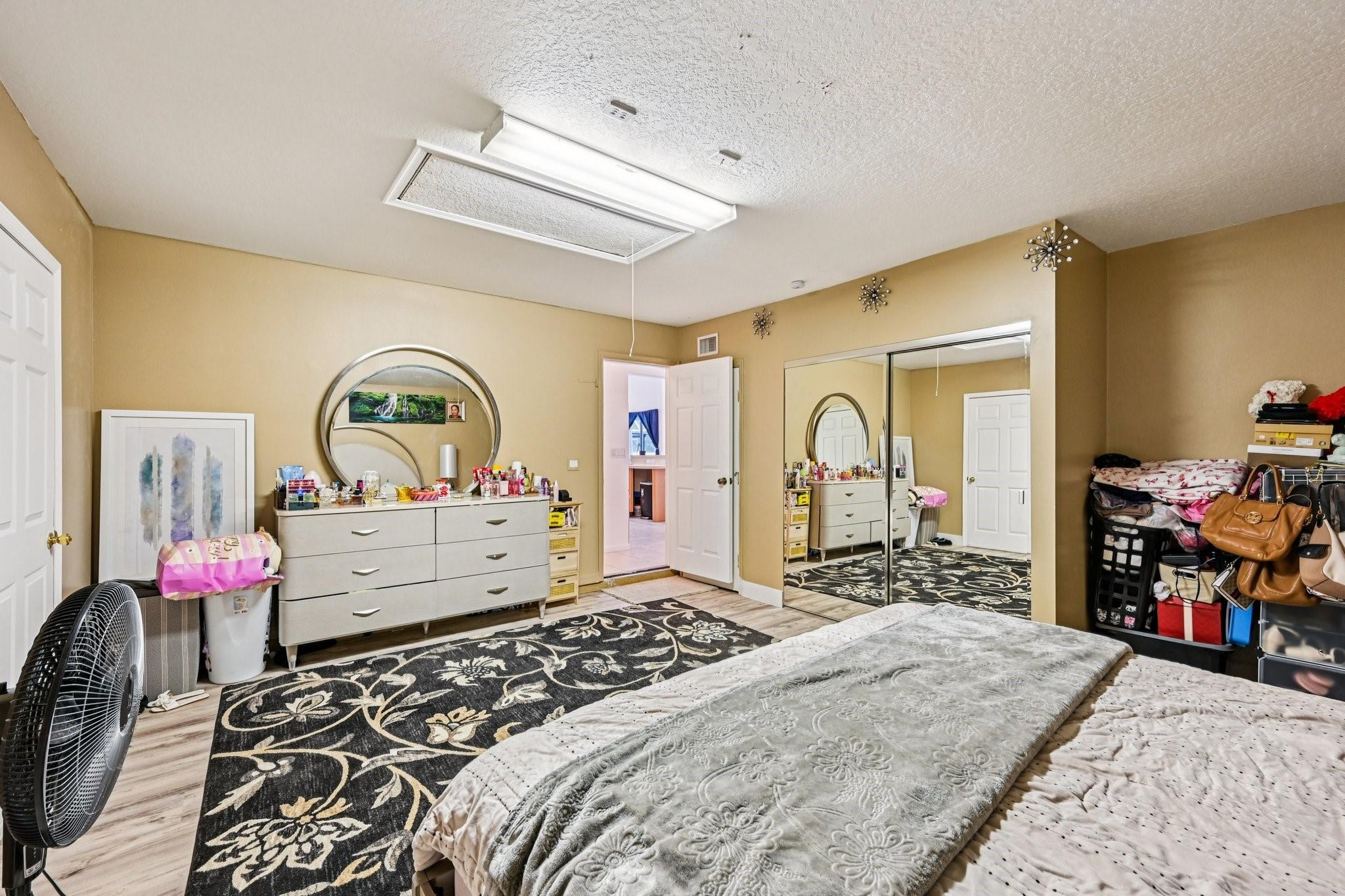 2041 Southwest Villanova Road Port St. Lucie, FL 34953 - Photo 24 of 45 a bedroom with a bed large mirror and dresser