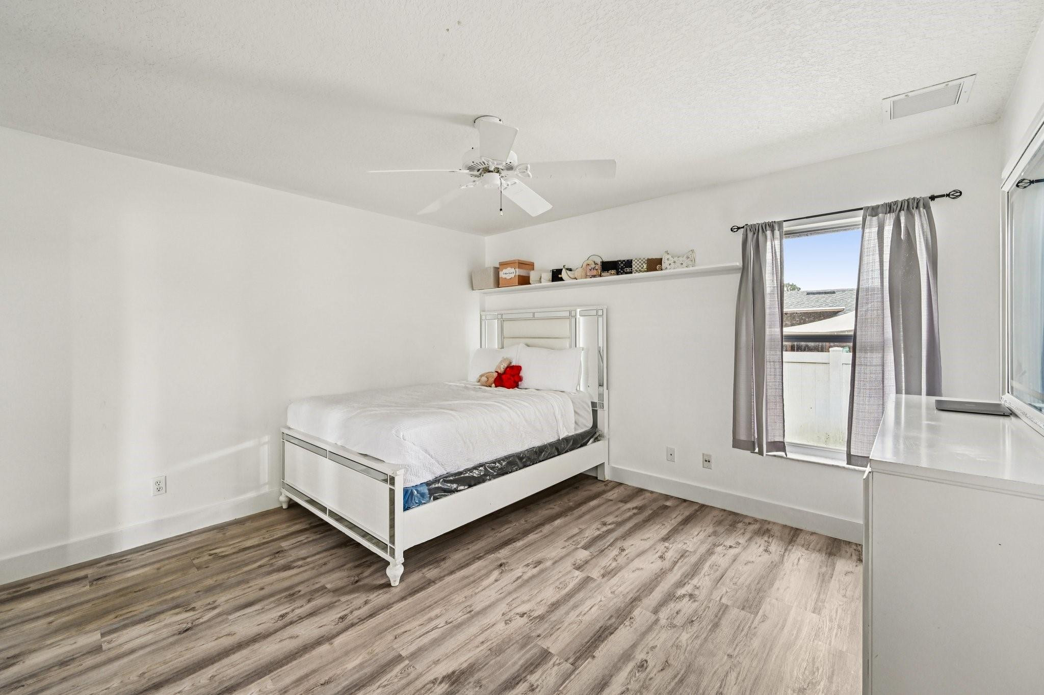 2041 Southwest Villanova Road Port St. Lucie, FL 34953 - Photo 26 of 45 a white bed sitting in a room next to a window