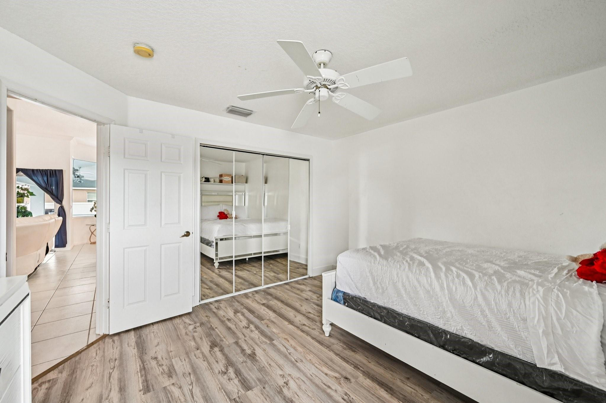 2041 Southwest Villanova Road Port St. Lucie, FL 34953 - Photo 27 of 45 a bedroom with a bed and a window