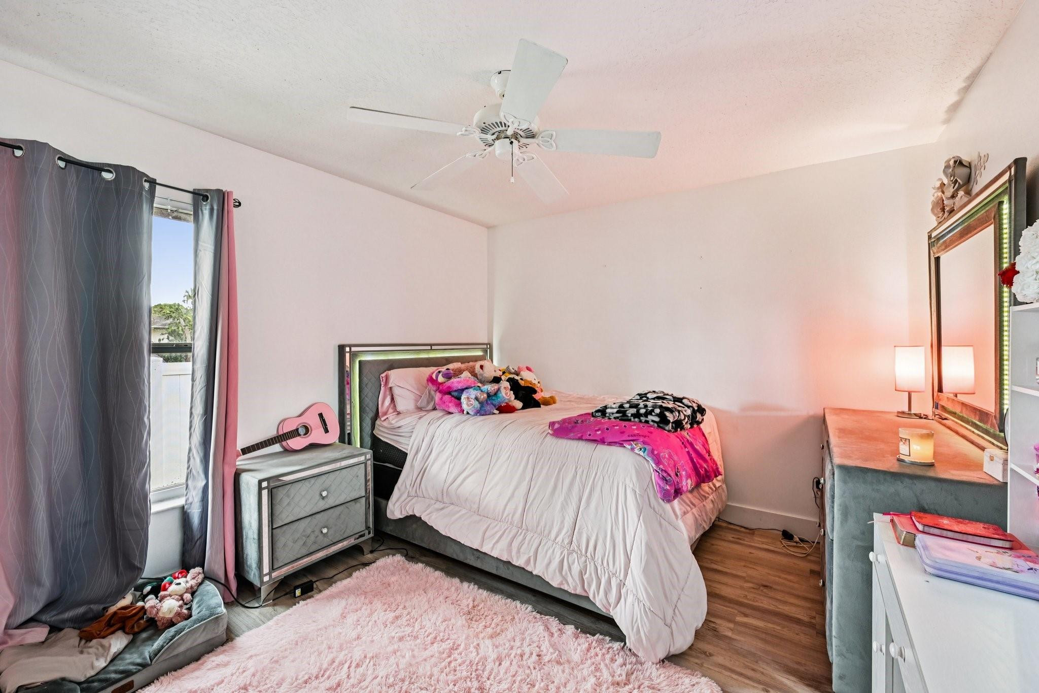 2041 Southwest Villanova Road Port St. Lucie, FL 34953 - Photo 28 of 45 a bedroom with a bed and a tv on the dresser