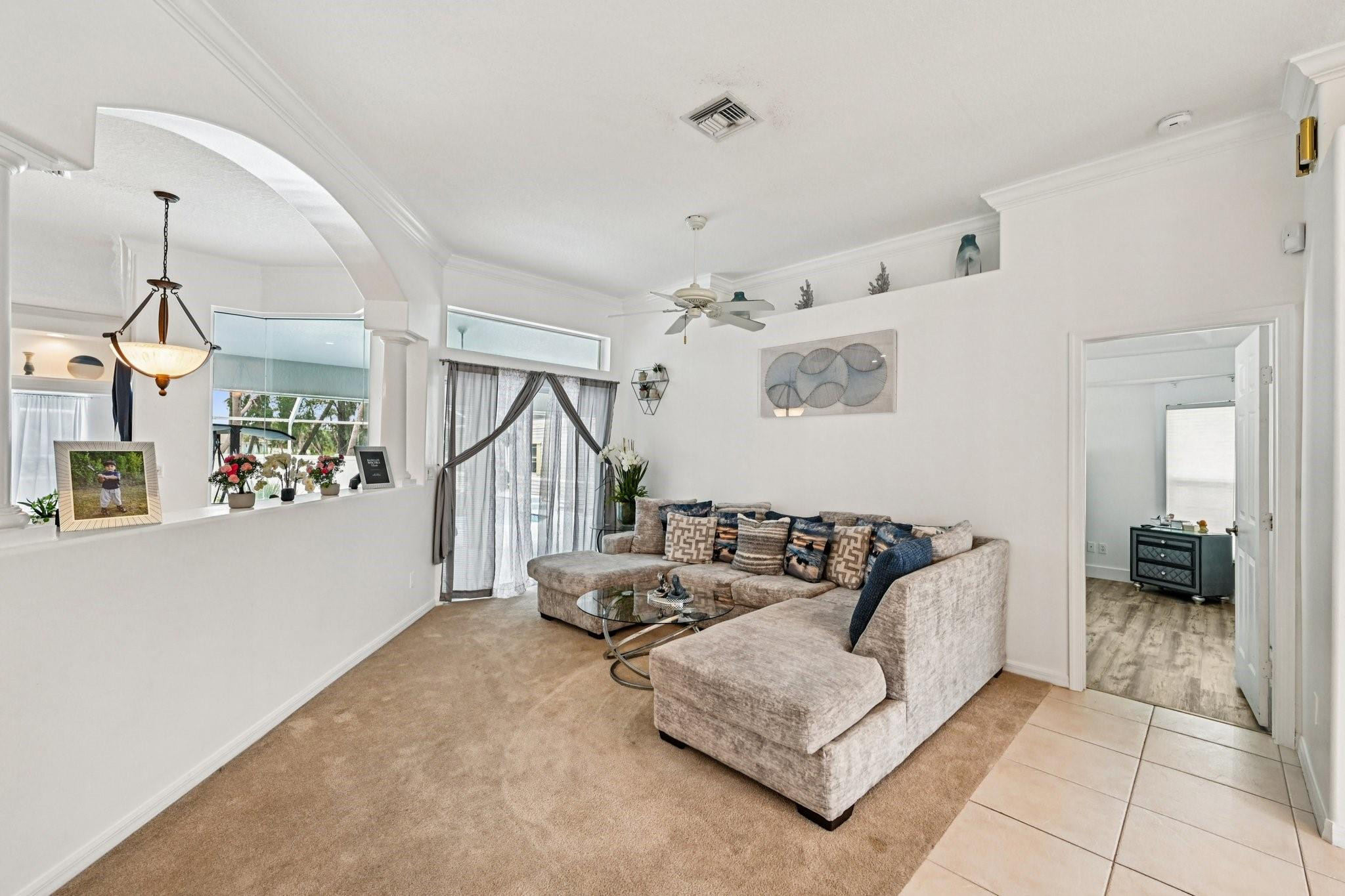 2041 Southwest Villanova Road Port St. Lucie, FL 34953 - Photo 7 of 45 a living room with furniture and a chandelier