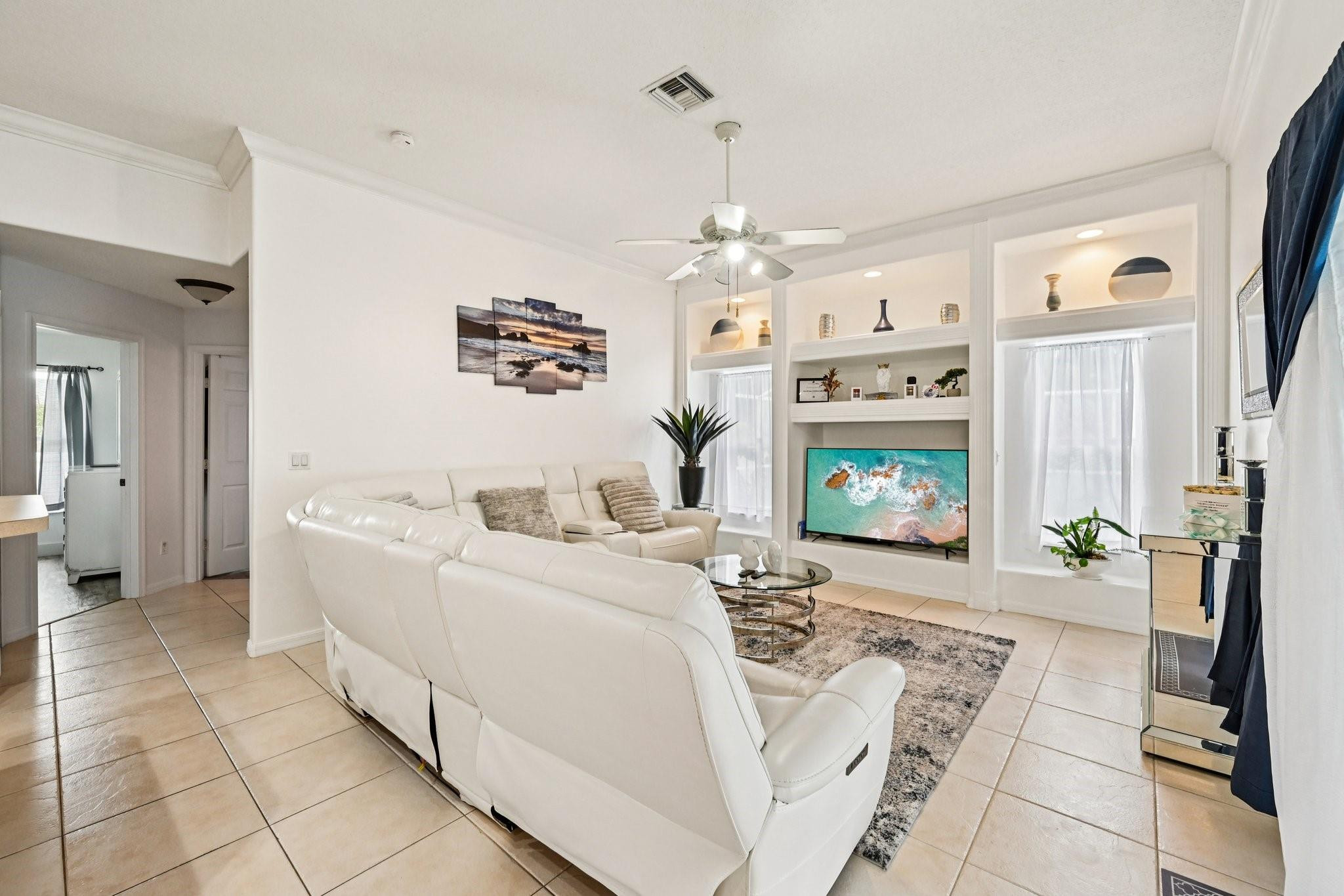 2041 Southwest Villanova Road Port St. Lucie, FL 34953 - Photo 9 of 45 a living room with furniture and a flat screen tv
